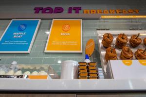 a display of muffins and other pastries in a bakery at Tru By Hilton Omaha I 80 At 72Nd Street, Ne in Omaha