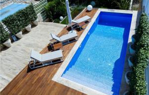 a swimming pool with lounge chairs and a swimming pool at Villa Oleander in Petrcane
