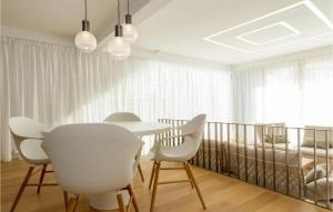 a dining room with a table and white chairs at Villa Oleander in Petrcane +26 photos