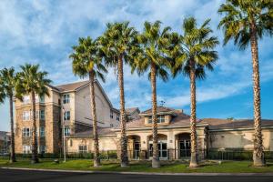 a group of palm trees in front of a building at Homewood Suites by Hilton Ontario Rancho Cucamonga in Rancho Cucamonga