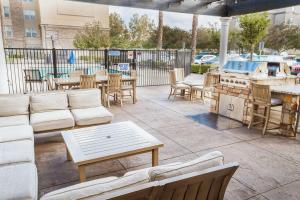 a patio with couches and tables and a grill at Homewood Suites by Hilton Ontario Rancho Cucamonga in Rancho Cucamonga