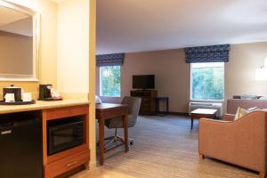 a kitchen and living room with a table and chairs at Hampton Inn Gloucester in Gloucester
