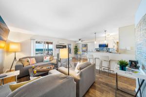 a living room with two couches and a kitchen at Waterfront North Wildwood Anglesea Family Retreat in North Wildwood