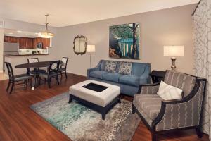 a living room with a couch and a table at Hilton Grand Vacations Club Tuscany Village Orlando in Orlando