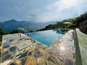 a swimming pool with a view of the mountains at Dolape Villa in Ella