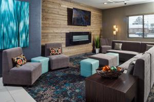 a living room with a couch and chairs and a tv at DoubleTree by Hilton Neenah in Neenah