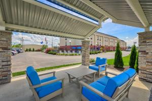 a patio with a table and chairs and a building at Hampton Inn Owensboro in Owensboro