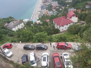 a bunch of cars parked in a parking lot at Goga Guest House in Kvariati