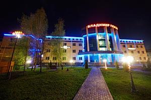 a building with a neon sign on it at night at Vladimir Plaza in Bryansk