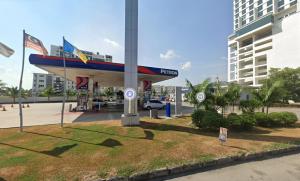 a gas station with a plane on top of it at Cozy Studio 3pax, Menara Sentral by VL HOME in Bukit Mertajam