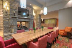 a conference room with a table and chairs and a fireplace at Hilton Garden Inn Pigeon Forge in Pigeon Forge