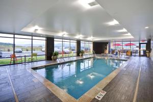 a large swimming pool in a building with windows at Home2 Suites By Hilton Pigeon Forge in Pigeon Forge