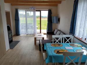 a living room with a table and a couch at Apartmány u Olšinské kapličky in Horní Planá