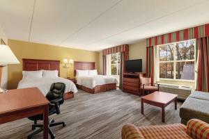 Habitación de hotel con 2 camas y TV de pantalla plana. en Hampton Inn & Suites Williamsburg Historic District, en Williamsburg