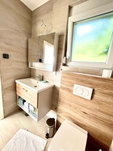 a small bathroom with a sink and a window at Bungalow Dream Oasis Dobra Voda in Dobra Voda