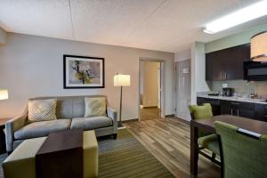 a living room with a couch and a table at Homewood Suites by Hilton Philadelphia-Great Valley in Malvern