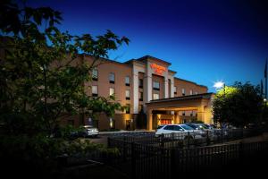 a hotel with cars parked in a parking lot at Hampton Inn Limerick in Limerick