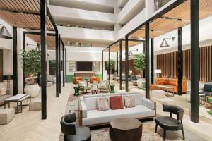 a lobby with a white couch and chairs and tables at Embassy Suites by Hilton Philadelphia Valley Forge in Wayne