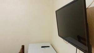 a flat screen tv sitting on top of a table at HOIMA KOLPING HOTEL in Hoima +14 photos