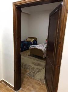 a mirror in a room with a bedroom with a bed at Your cozy apartment in Al-Karak in Kerak