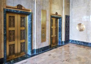 a lobby with three doors in a building at Hilton Garden Inn Phoenix Downtown in Phoenix