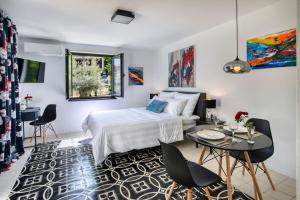 a bedroom with a bed and a table and chairs at My Place Hvar in Stari Grad +136 photos
