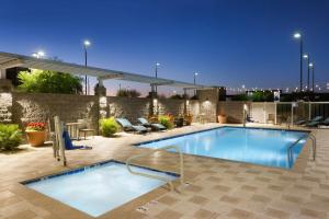 a swimming pool on the roof of a building at Home2 Suites By Hilton Glendale Westgate in Glendale