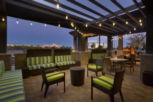 a patio with furniture and a table and chairs at Home2 Suites By Hilton Glendale Westgate in Glendale