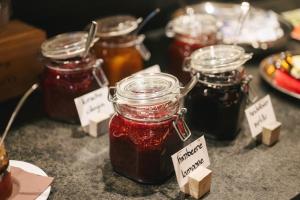 a group of jars of jam on a table at Weingut & Genusshotel Spitalerhof Superior in Chiusa