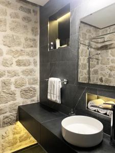 a bathroom with a white sink and a mirror at KAŽIN supreme in Kotor