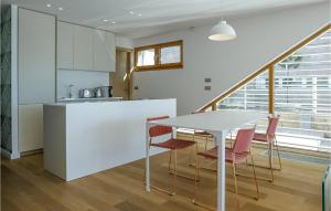 a kitchen and dining room with a table and chairs at Villa Calla in Petrcane