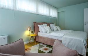 a bedroom with a large bed and two chairs at Villa Calla in Petrcane