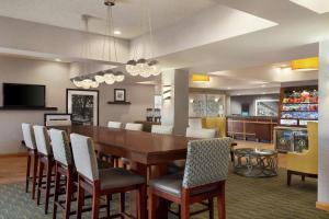 a dining room and living room with a table and chairs at Hampton Inn Phoenix Midtown Downtown Area in Phoenix