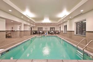 a swimming pool in a building with a large pool at Hampton Inn & Suites North Huntingdon-Irwin, PA in Irwin