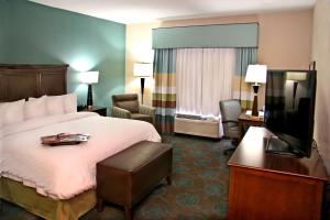 a hotel room with a bed and a flat screen tv at Hampton Inn Bridgeville in Bridgeville +26 photos