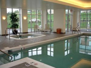 a large swimming pool in a large building with a pool at Hampton Inn & Suites Pittsburgh-Meadow Lands in Washington