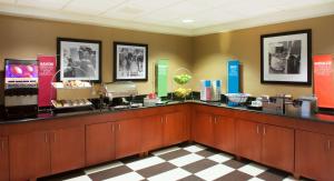a restaurant with a counter with a food counter at Hampton Inn & Suites Pittsburgh-Meadow Lands in Washington