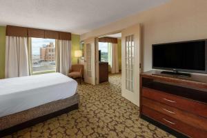 a hotel room with a bed and a flat screen tv at Hilton Garden Inn Pittsburgh University Place in Pittsburgh