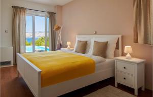 a bedroom with a bed with a yellow blanket and a window at Villa 6 Mala Rudina in Rudina