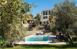 a villa with a swimming pool and a building at Villa Stella Maris in Suđurađ