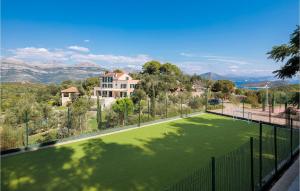 a tennis court in front of a house at Villa Stella Maris in Suđurađ