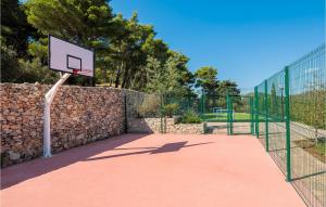 a basketball hoop with a stone wall and a basketball net at Villa Stella Maris in Suđurađ +29 photos