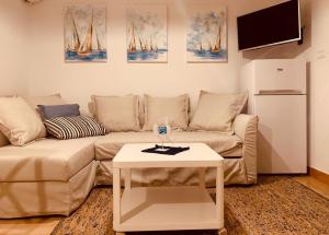 a living room with a couch and a table at Hiška on the cliff in Ankaran +7 photos