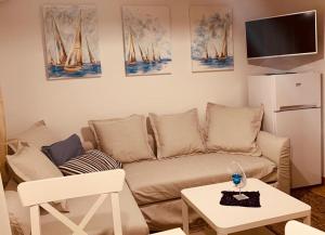 a living room with a couch and a table at Hiška on the cliff in Ankaran