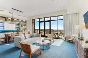 a living room with a couch and a table at The Lodge at Gulf State Park, A Hilton Hotel in Gulf Shores