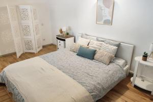 a bedroom with a large bed with pillows on it at Charmant duplex en centre-ville in Le Mans