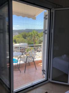 a sliding glass door with a view of a patio at Villa Alexandra in Agia Marina Aegina