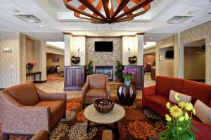 a lobby with couches chairs and a fireplace at Homewood Suites by Hilton Dover in Dover