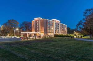 a large building with a lawn in front of it at Hampton Inn Norwich in Norwich