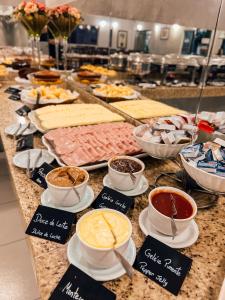 a buffet with different types of food on a table at Hotel Concord e Eventos corporativos Campo Grande in Campo Grande +32 photos
